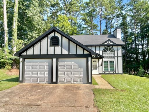 This Union City, GA home offers four bedrooms and two full bathrooms, with abundant natural light throughout the living areas. – photo 1