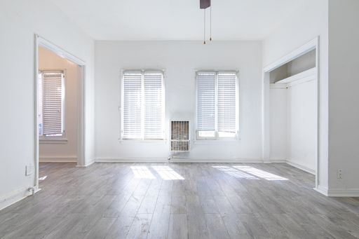 One Bedroom Featuring Exposed Brick – photo 1
