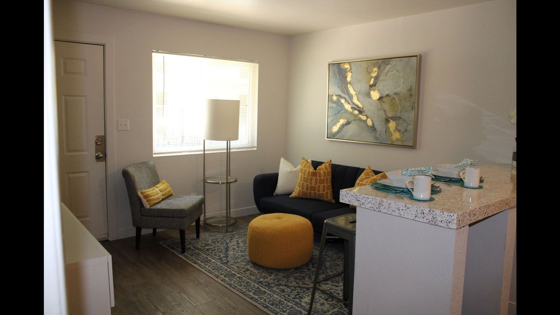 Furnished apartment living area shown — representative home at Elevate at South Mountain.