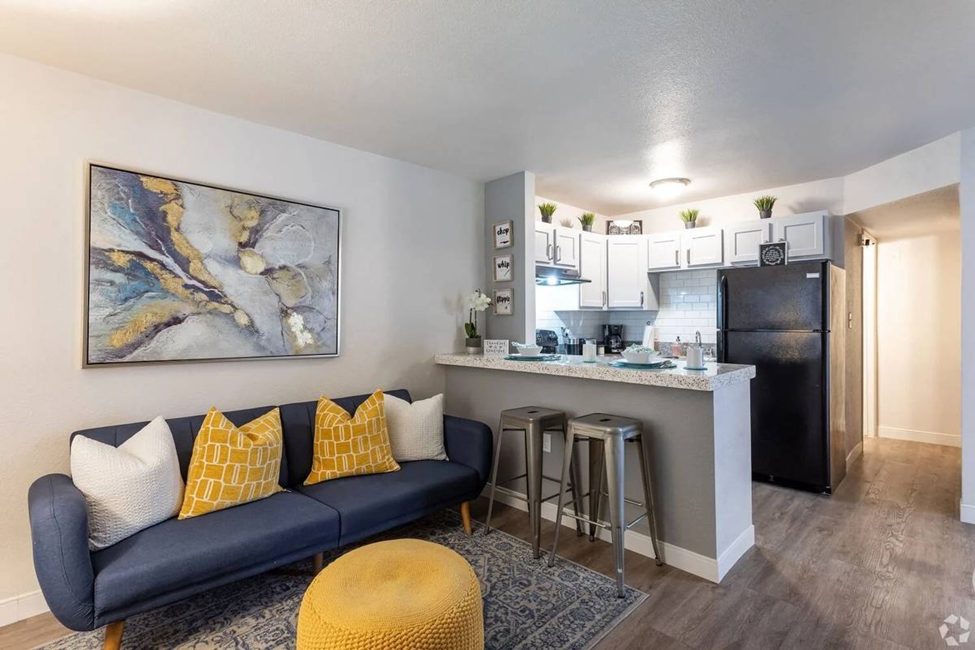 Furnished apartment living area shown — representative home at Elevate at South Mountain.