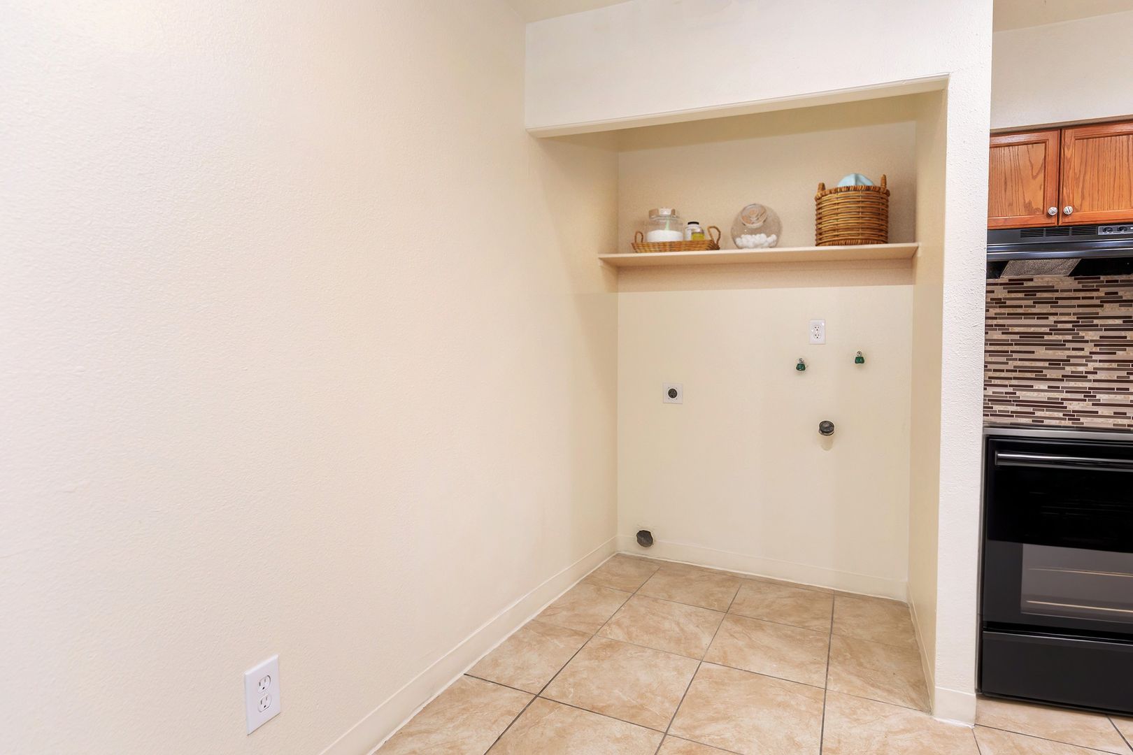 Washer and dryer hookup area at Lynnwood Apartments.