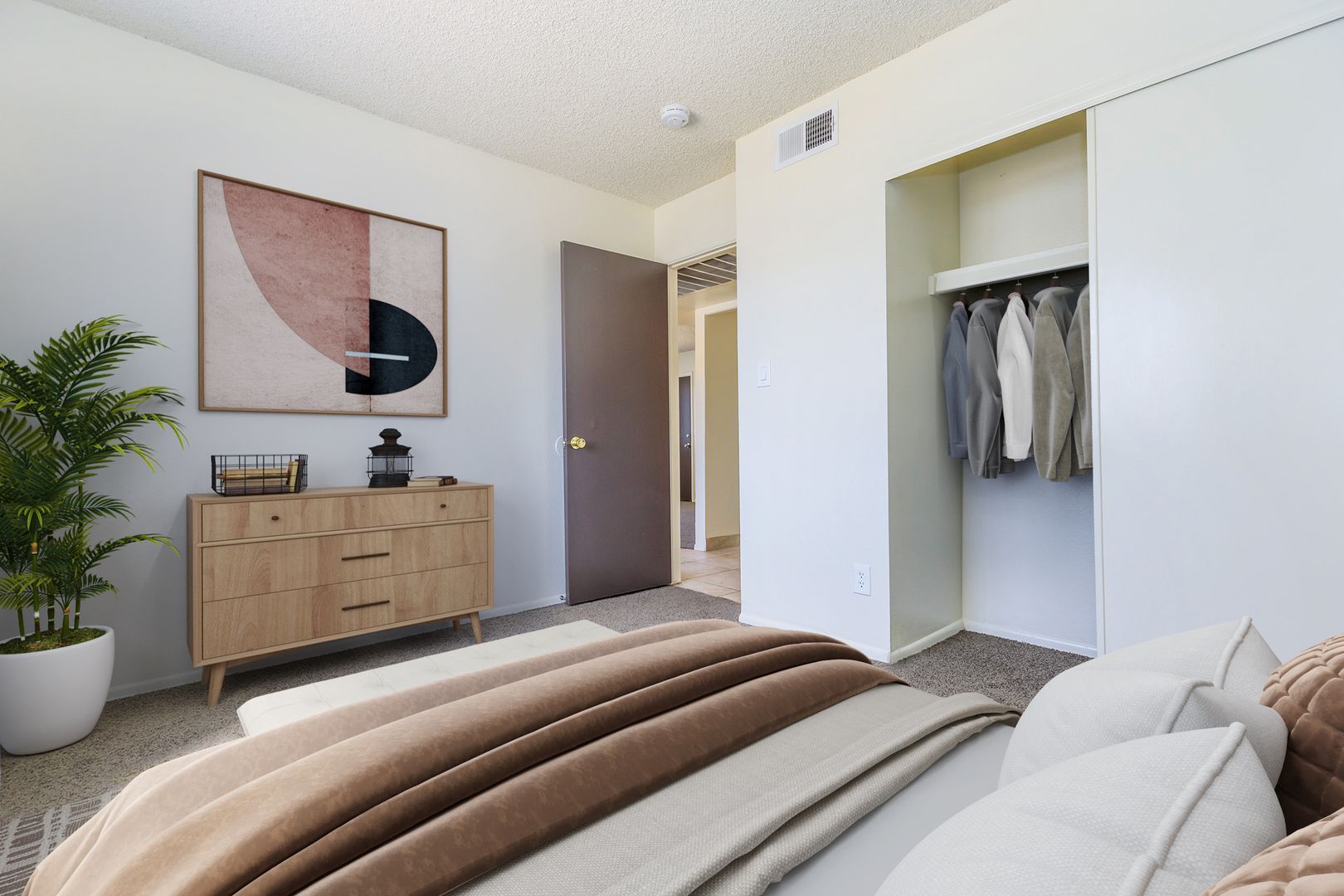 Furnished bedroom shown — representative home at Lynnwood Apartments.