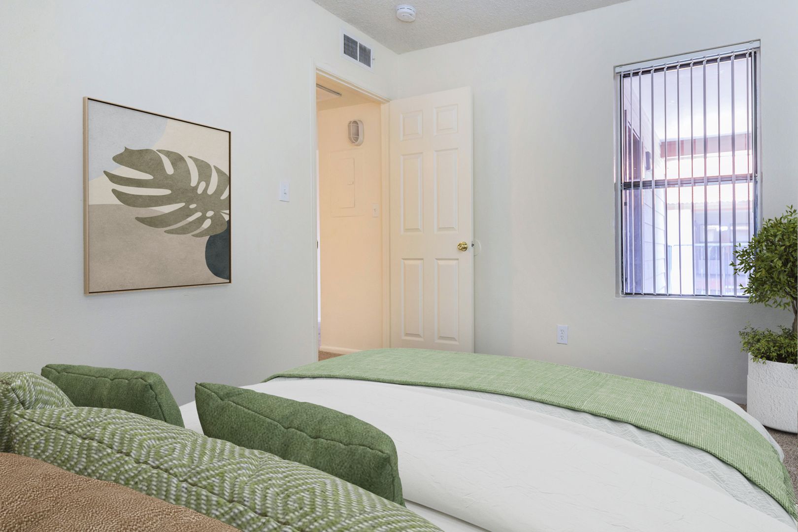 Furnished bedroom shown — representative home at Lynnwood Apartments.