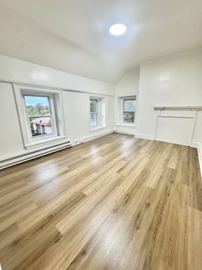 2-bedroom with light hardwood and a butcher block kitchen – photo 1