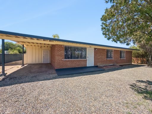 Spacious 5-Bedroom Brick Home with Large Fenced Yard | 6150 E 32nd St – photo 1
