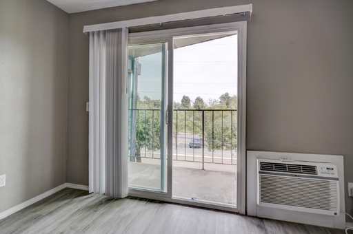 Bright and airy space featuring vaulted ceilings and a private balcony. – photo 1