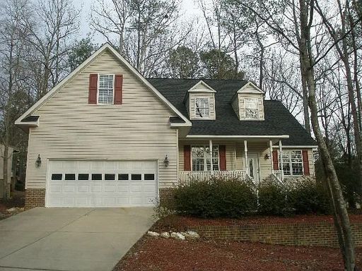 Backing directly to the golf course in the gated community of Carolina Trace, this spacious 3-bedroom, 2-bath ranch offers over 2,000 square feet of living space, a large bonus room, screened porch, gas log fireplace, formal dining room, and attached two – photo 1