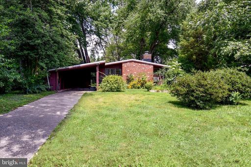Enjoy the ease of one-level living in this charming rustic contemporary home, tucked away among mature trees in the highly desirable Holmes Run Acres community. – photo 1