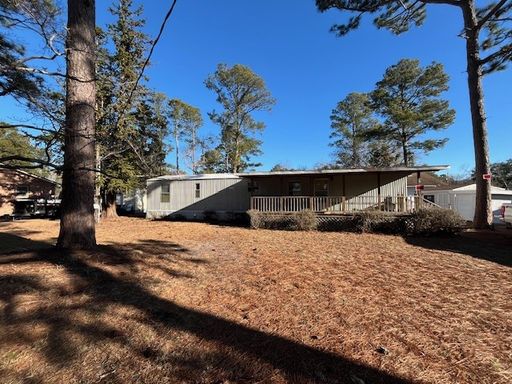 Welcome to this charming 2-bedroom, 1.5-bathroom home located in the desirable area of Leland, NC – photo 1