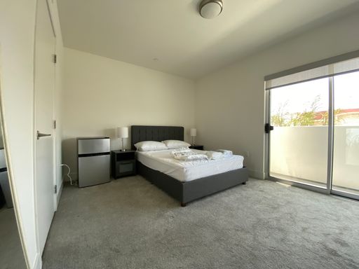 Large furnished master bedroom with a private bathroom – photo 1