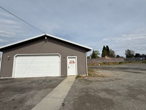 Commercial lot with a garage and fenced yard – photo 1