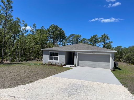 Beautiful four bedroom, two bath, two car garage and a half acre lot