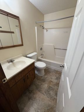 Carpeted 2-bed, 1-bath Townhome with a Garage Stall! – photo 1