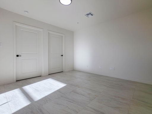 Unit 1 room with closet and interior doors.