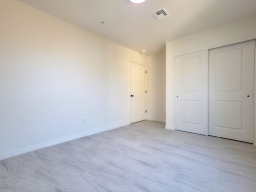Unit 3 bedroom with double closet doors.
