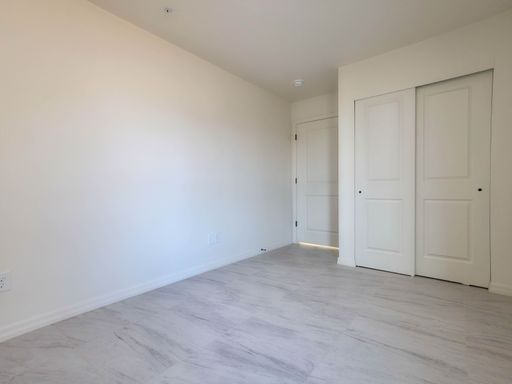 Unit 1 bedroom with double closet doors.