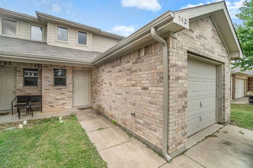 Beautiful two story townhome, crown molding, granite countertops, stained cabinets and carpeting in living area.