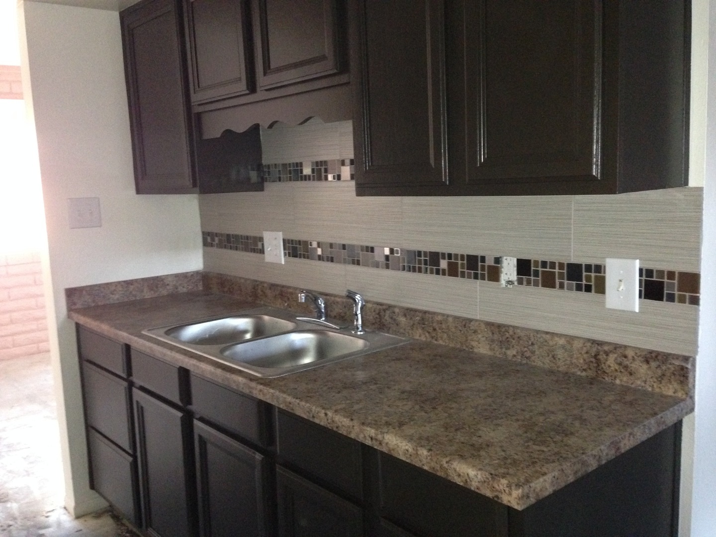 Kitchen counter and dark cabinetry — view 1 at Renovatio Apartments.
