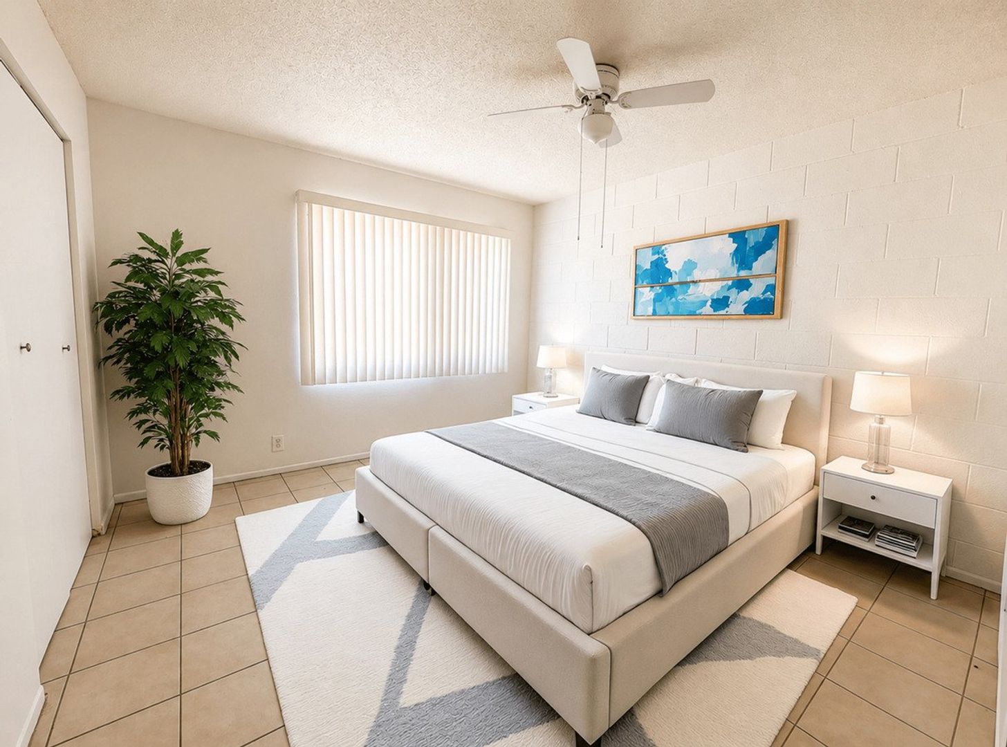 Furnished bedroom shown — representative home at 12 Palms Apartments.