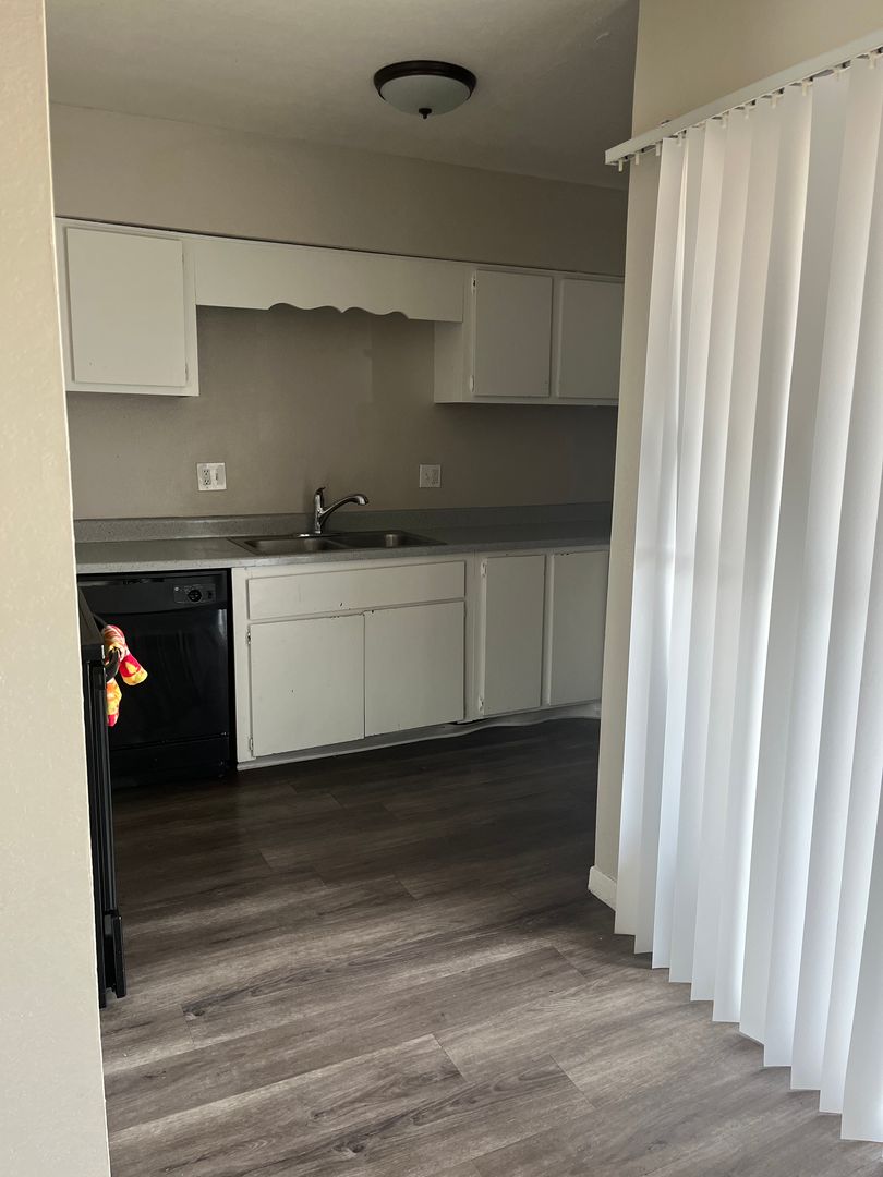 Apartment kitchen shown in Apartment 219 at Courtyard Village Apartments.