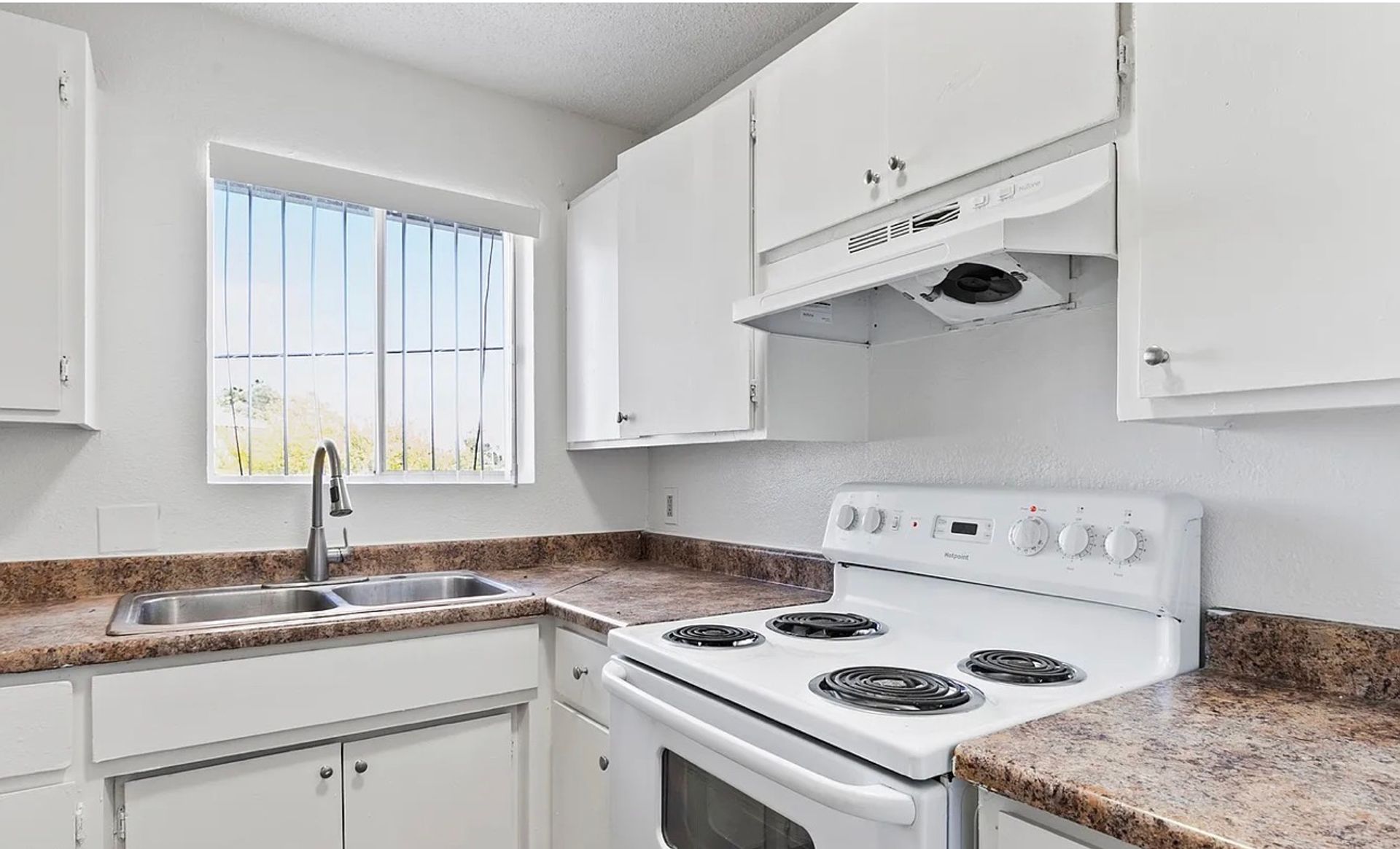 Kitchen sink, counters and range at Glen Vista Apartments